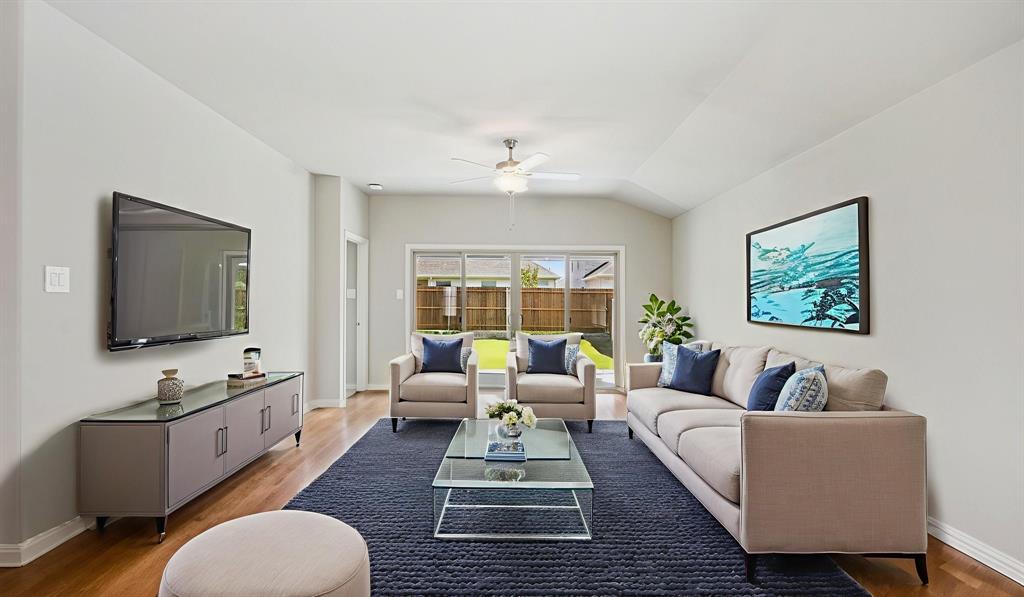 2215 Currents Road Princeton, TX 75407 - Photo 8 of 37 a living room with furniture flat screen tv and a large window