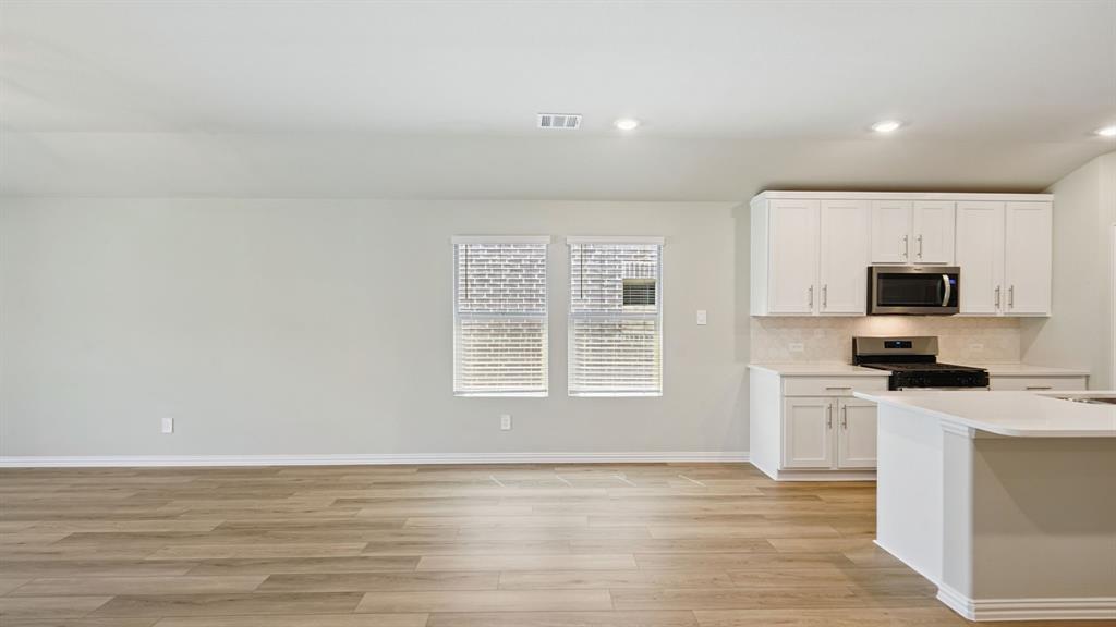 2215 Currents Road Princeton, TX 75407 - Photo 9 of 37 a view of a kitchen with microwave and cabinets