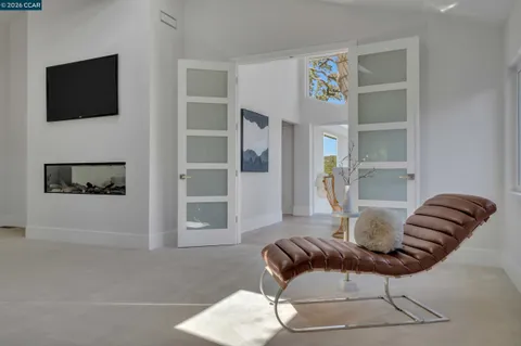 a spacious bedroom with a bed and a painting on the wall