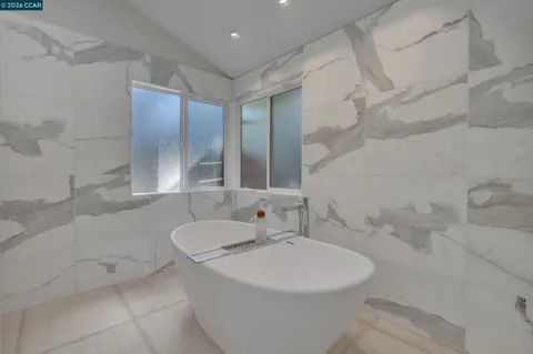 a white bath tub sitting next to a bathroom