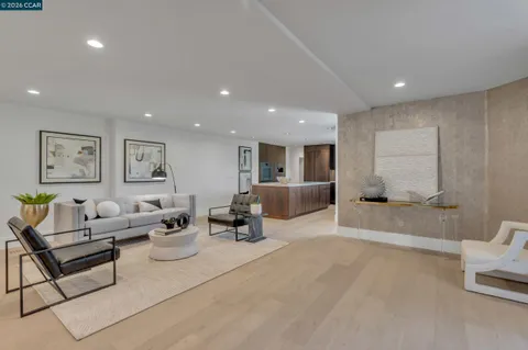 a living room with furniture and view of kitchen