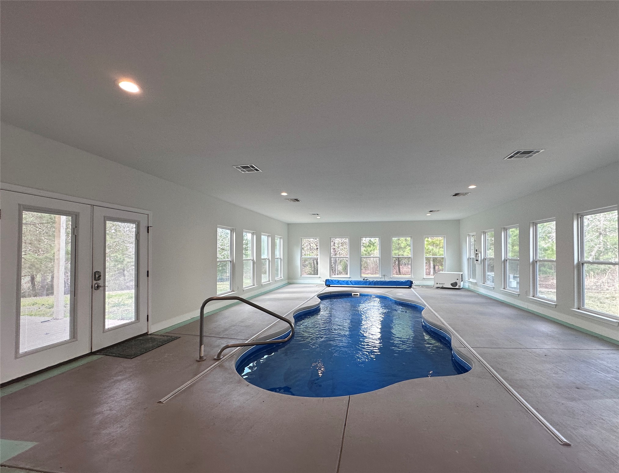 124 Pine Path Bastrop, TX 78602 - Photo 21 of 31 Pool with french doors and a hot tub on the back porch