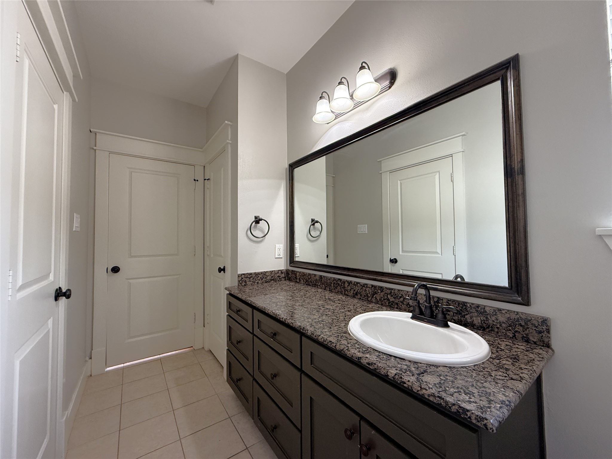 5237 Center Street Houston, TX 77007 - Photo 13 of 27 a bathroom with a granite countertop sink and a mirror