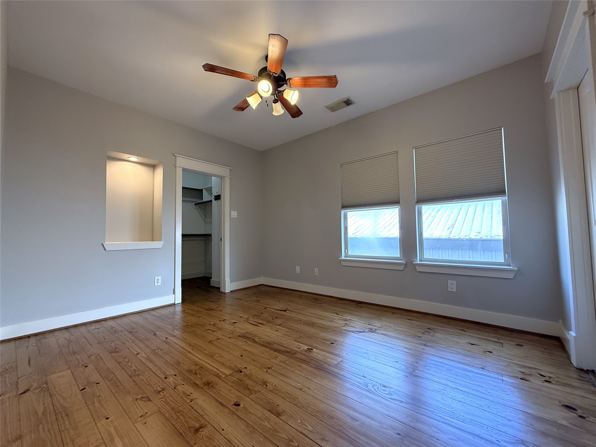 5237 Center Street Houston, TX 77007 - Photo 15 of 27 a view of an empty room with wooden floor and a window