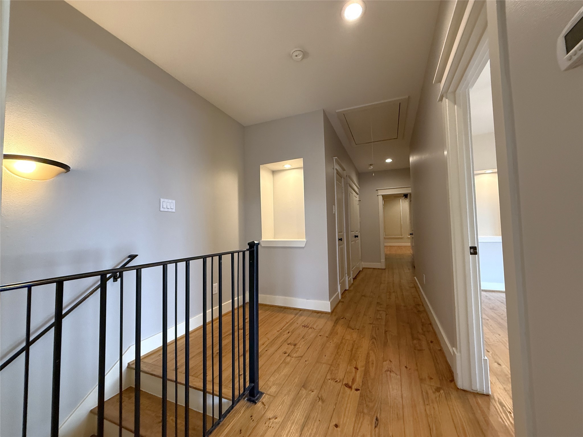 5237 Center Street Houston, TX 77007 - Photo 17 of 27 a view of a hallway with wooden floor and a bathroom