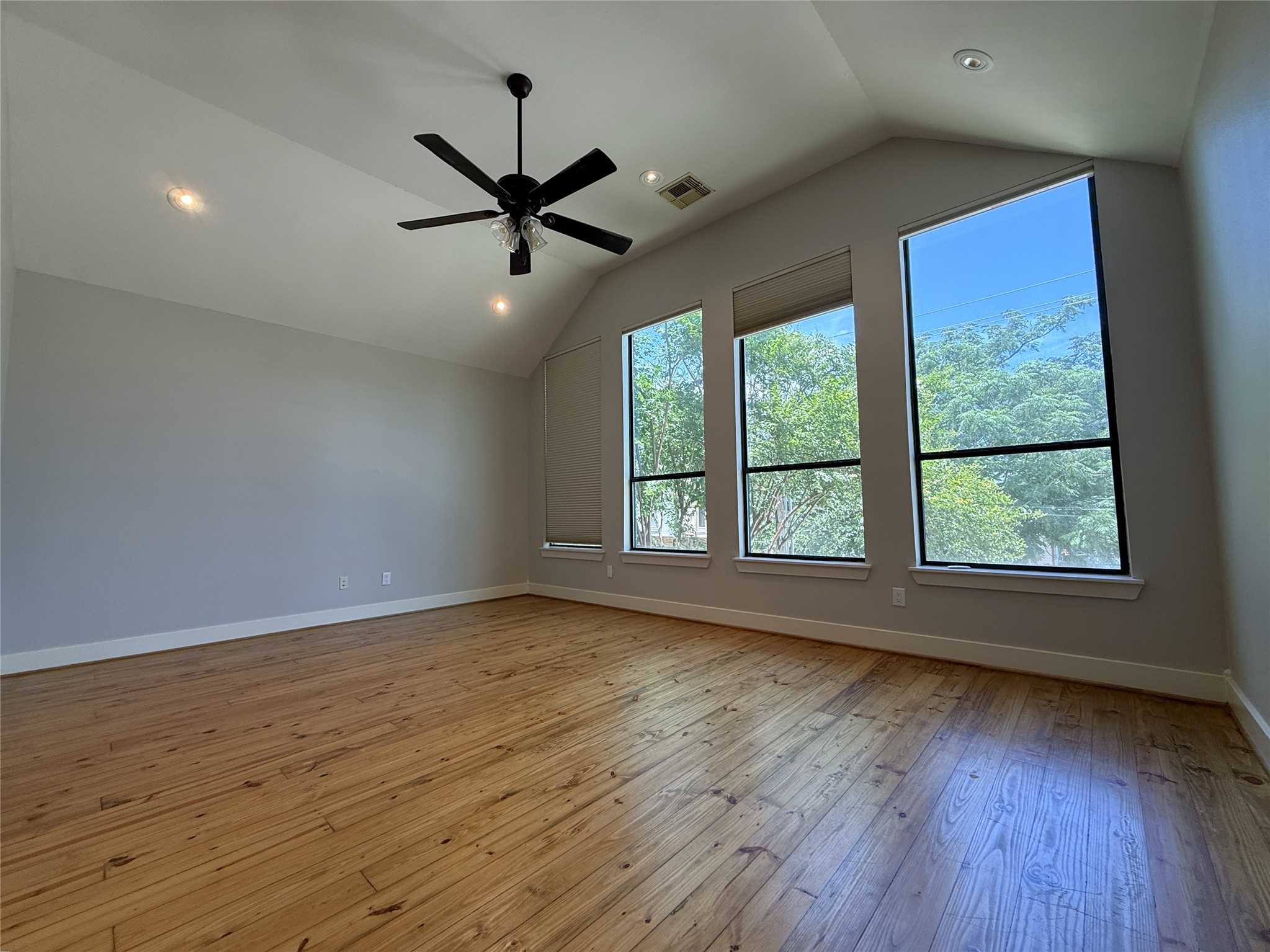 5237 Center Street Houston, TX 77007 - Photo 26 of 27 an empty room with wooden floor fan and windows