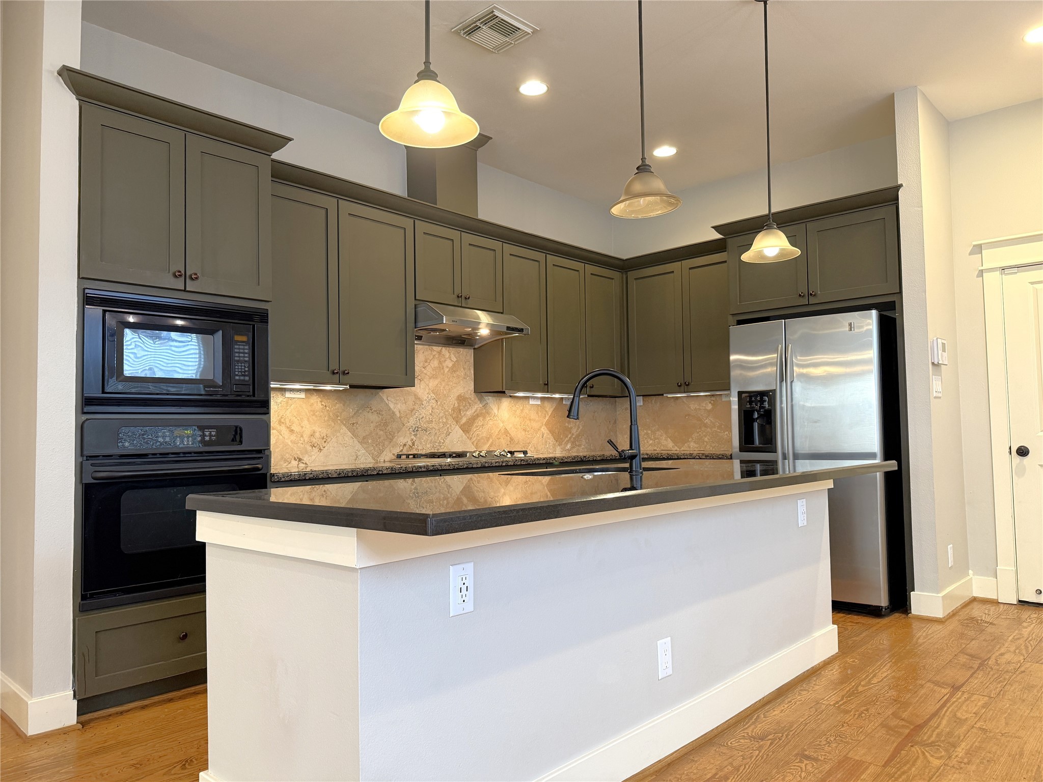 5237 Center Street Houston, TX 77007 - Photo 3 of 27 a kitchen with kitchen island a sink and stainless steel appliances