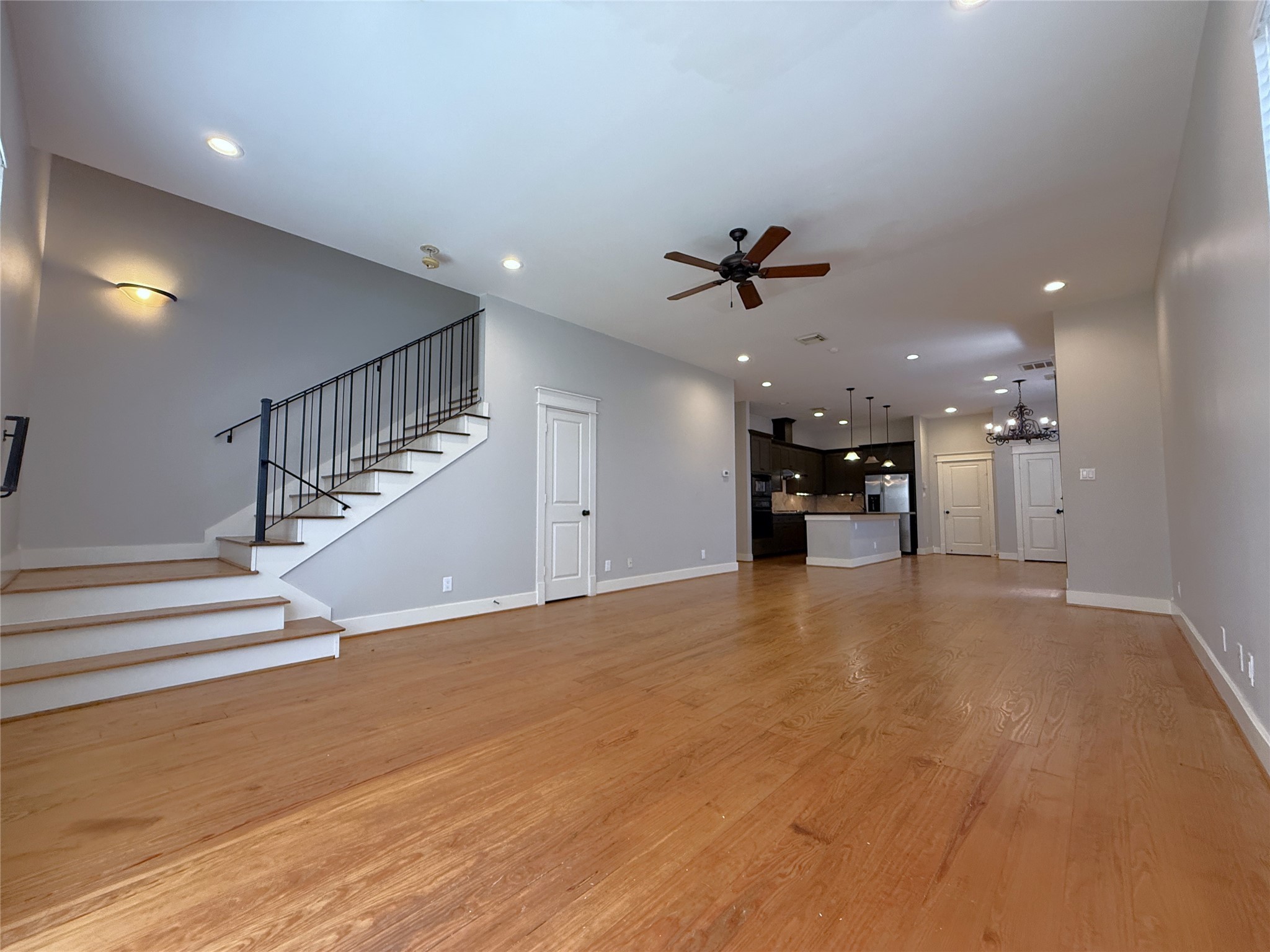 5237 Center Street Houston, TX 77007 - Photo 8 of 27 a view of an empty room with wooden floor and a ceiling fan
