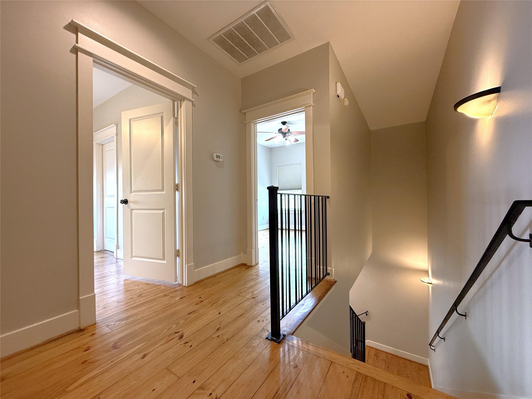5237 Center Street Houston, TX 77007 - Photo 9 of 27 a view of a hallway with wooden floor and staircase