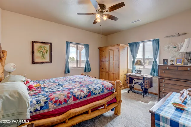 a bedroom that has a bed and a table in it