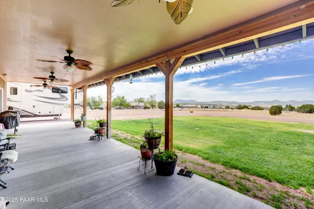a view of a porch with furniture and garden