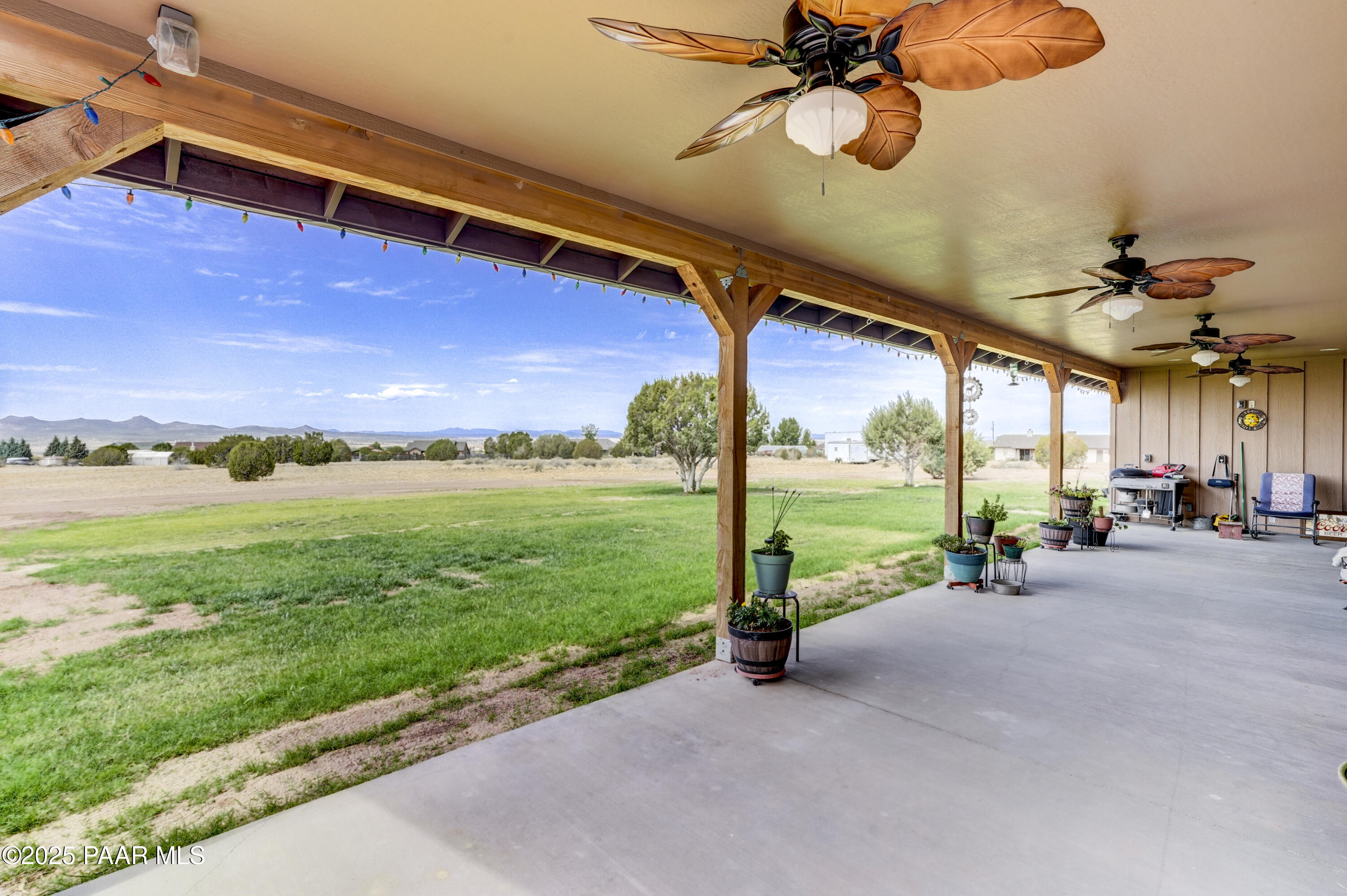 24720 North Rj Way Paulden, AZ 86334 - Photo 24 of 43 a view of a patio with a table chairs and a backyard