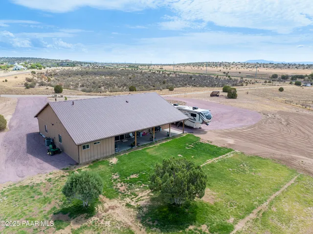 an aerial view of a house with a garden and mountain view
