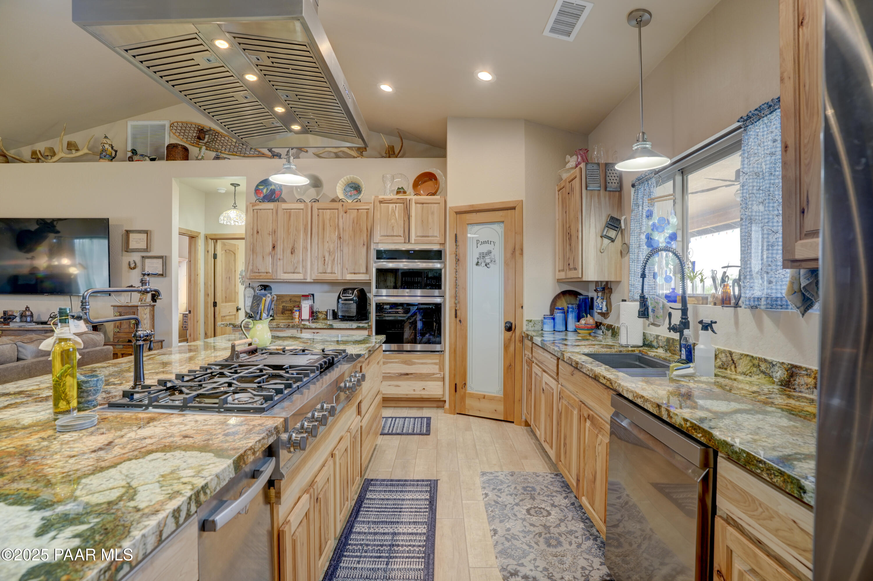 24720 North Rj Way Paulden, AZ 86334 - Photo 6 of 43 a kitchen with stainless steel appliances kitchen island granite countertop a stove and refrigerator
