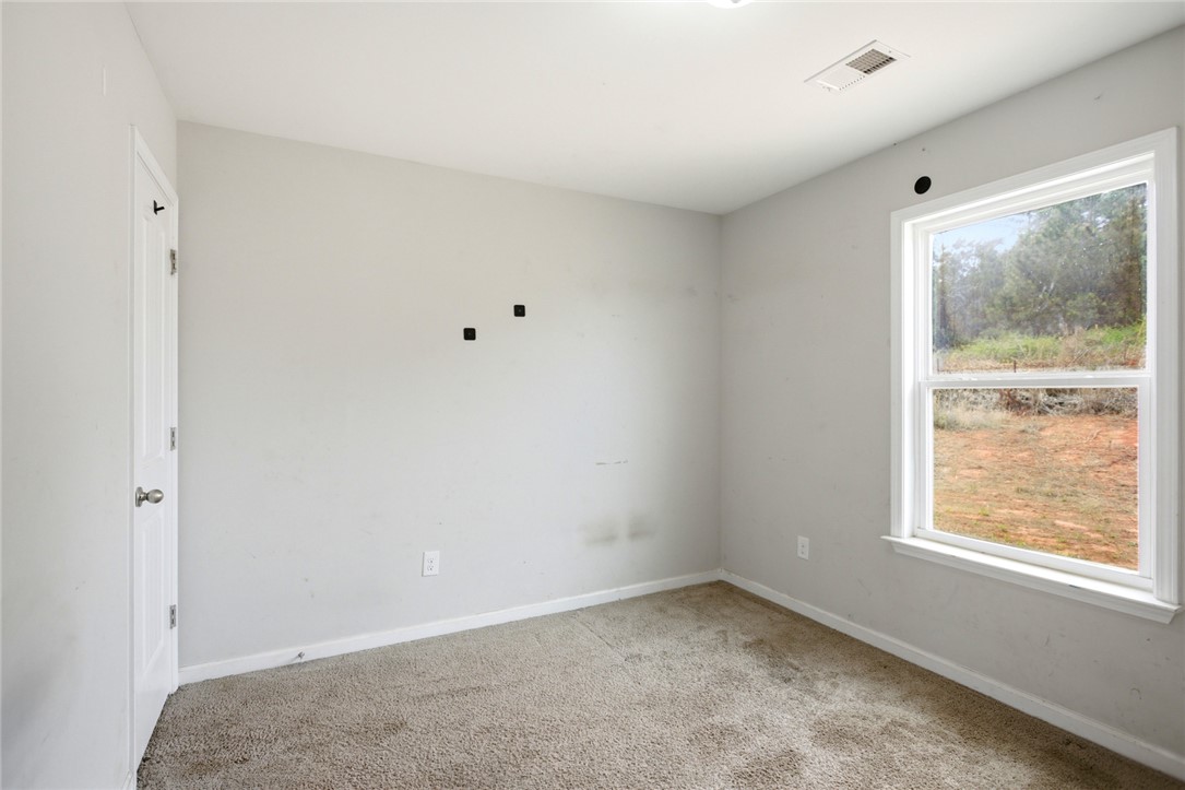 245 Maple Grove Road Seneca, SC 29678 - Photo 27 of 40 This spacious room offers comfortable carpeted flooring and ample natural light.