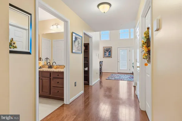 a view of walk in closet with wooden floor