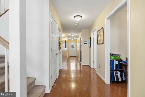 a view of hallway with wooden floor