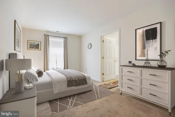 a bedroom with a bed and a dresser