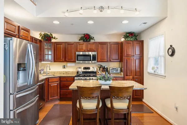 a kitchen with a refrigerator and a dining table