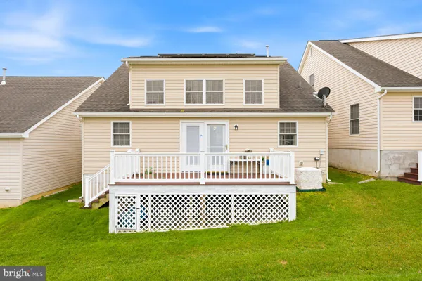 a picture of a bench in front of a white house