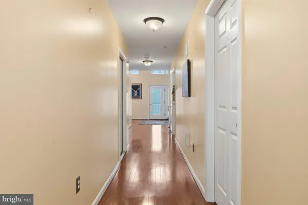 a view of a hallway with wooden floor