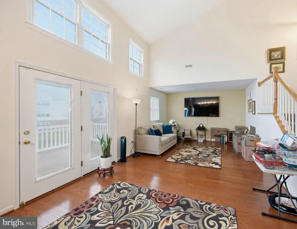 a living room with furniture wooden floor and a rug