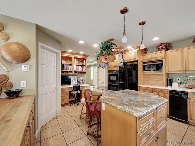 a kitchen with a stove a refrigerator and a fireplace
