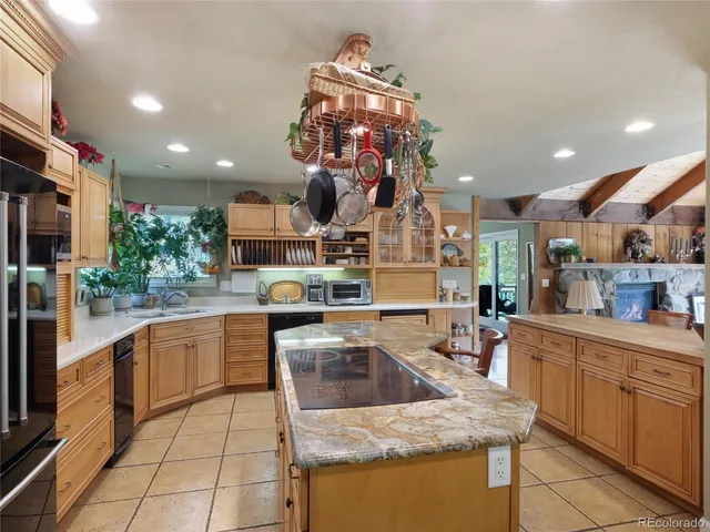 a kitchen with stainless steel appliances granite countertop a sink counter space cabinets and a stove