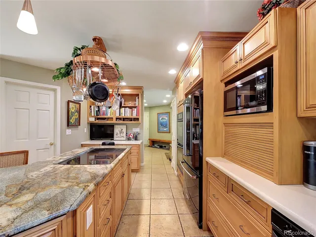 a kitchen with a stove a refrigerator and a sink