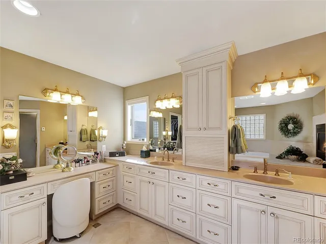 a spacious bathroom with double vanity a mirror a double vanity sinks and a mirror