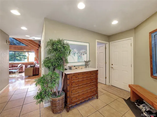 a room with furniture and potted plants