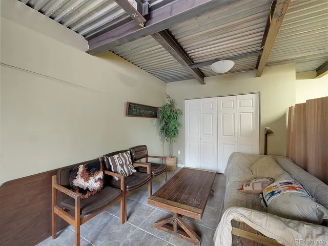 an aerial view of green landscape with trees houses and mountain view