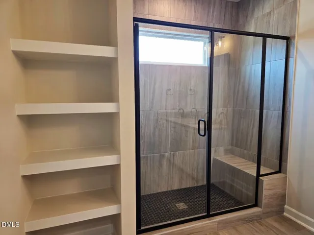 a bathroom with a glass shower door