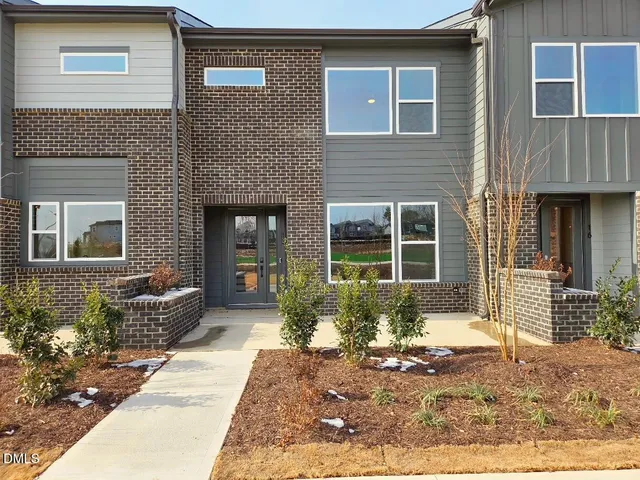 a front view of a house with outdoor space