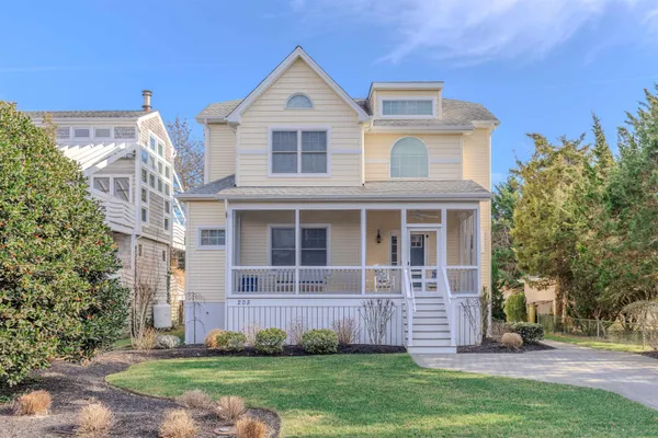 a view of a balcony with chairs and wooden floor