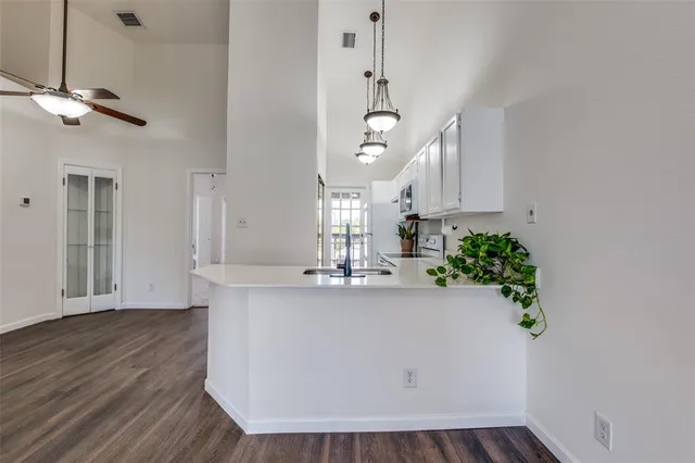 a view of a kitchen and chandelier