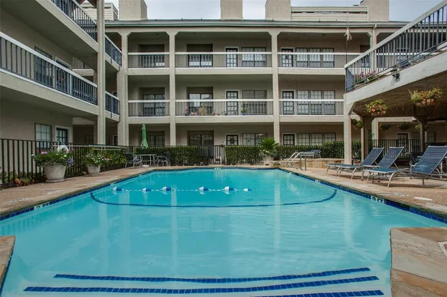 a view of a house with swimming pool and sitting area
