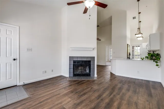 a view of a livingroom with wooden floor and a fireplace
