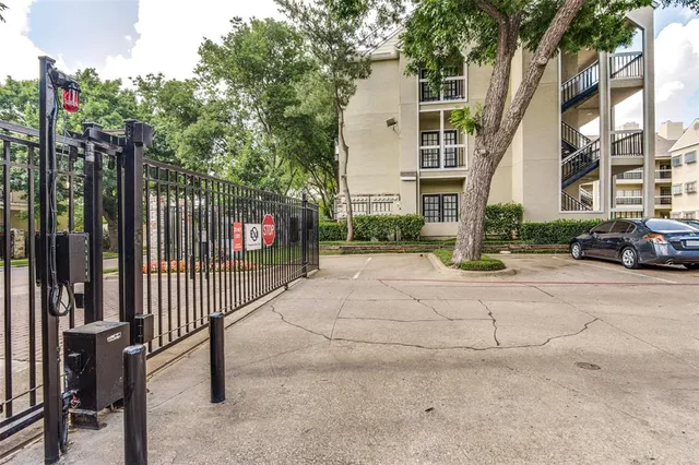 a patio with a table and chairs and potted plants