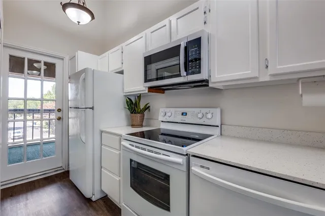 a kitchen with stainless steel appliances white cabinets and a stove