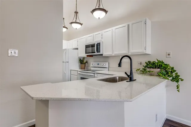 a kitchen with stainless steel appliances a sink a counter space and cabinets