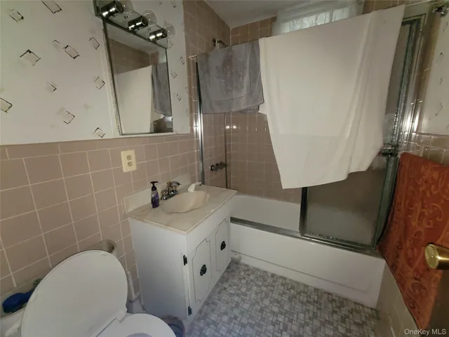 a bathroom with a sink mirror toilet and shower