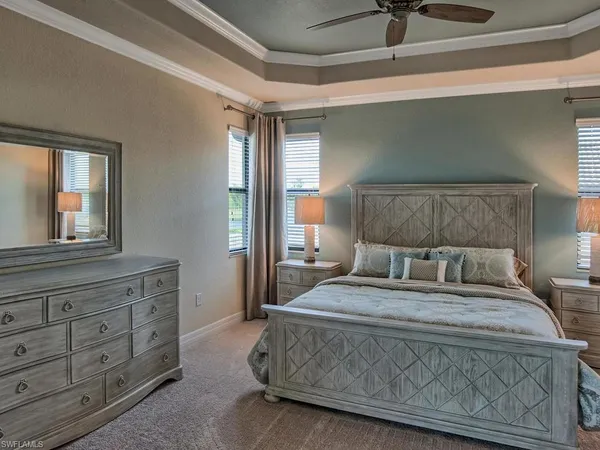 a bedroom with a large bed and a dresser