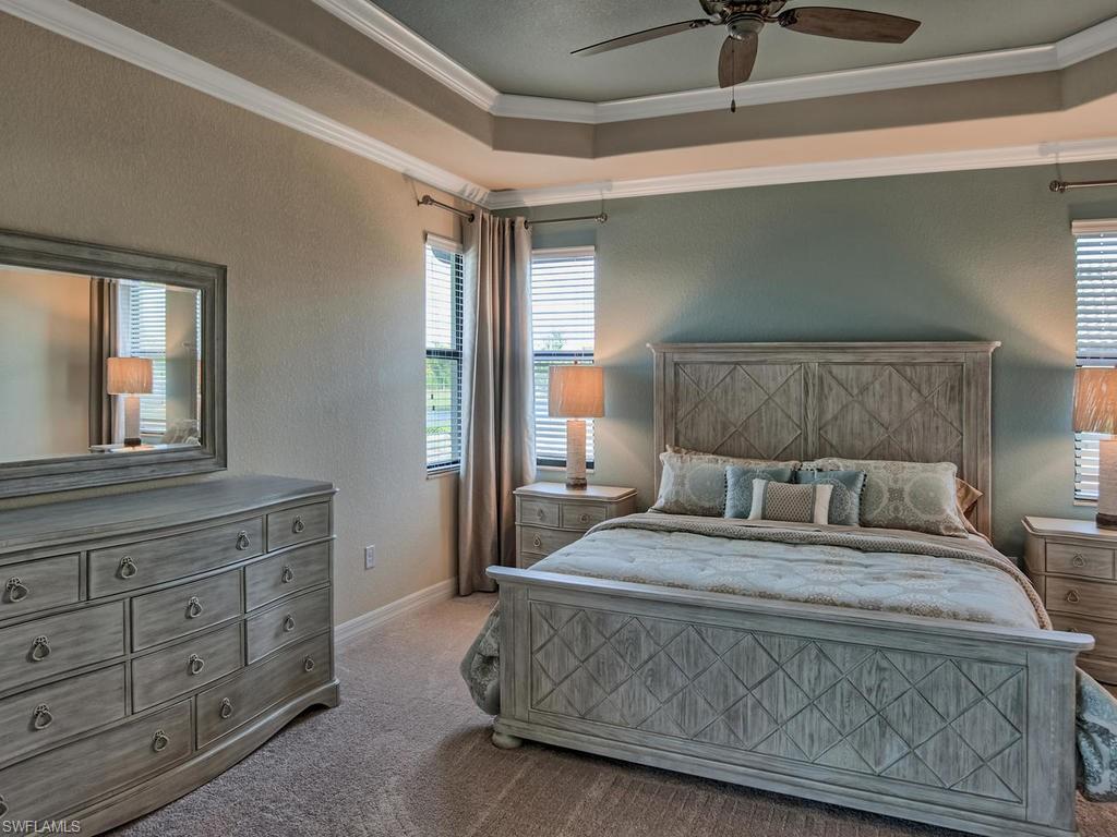 2850 Aviamar Circle Naples, FL 34114 - Photo 12 of 26 a bedroom with a large bed and a dresser