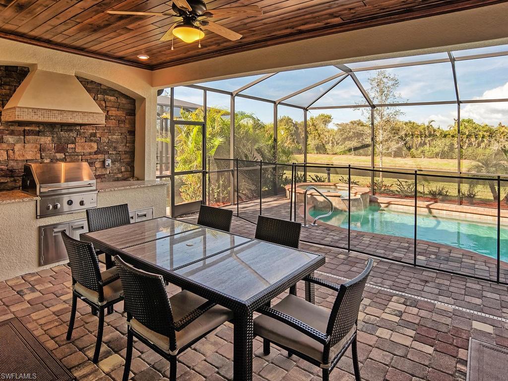2850 Aviamar Circle Naples, FL 34114 - Photo 2 of 26 a view of a dining table and chairs in the patio