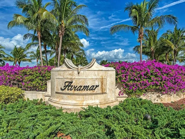 a sign that is sitting in front of flowers