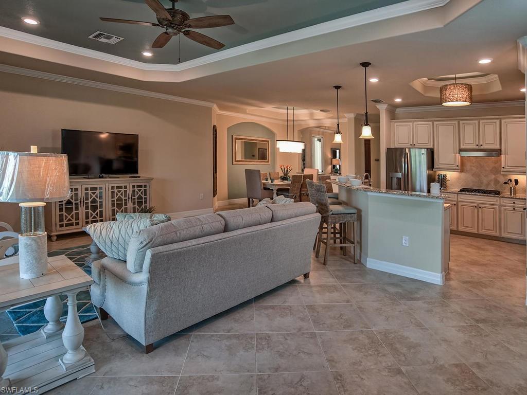 2850 Aviamar Circle Naples, FL 34114 - Photo 7 of 26 a living room with furniture and a flat screen tv