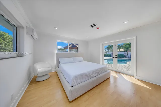 a spacious bedroom with a bed and a window