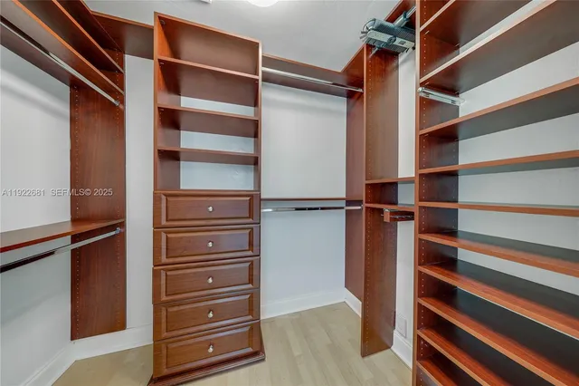 a view of walk in closet with empty racks