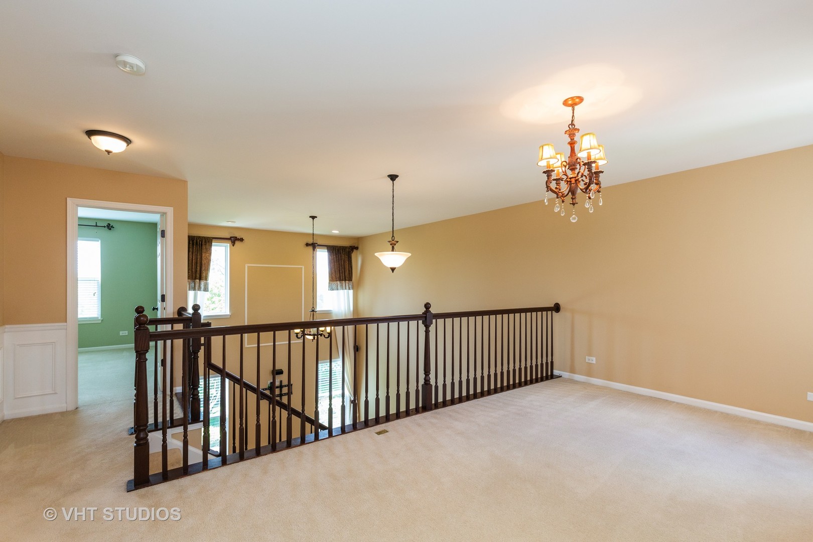 973 Oak Ridge Boulevard, Unit 973 Elgin, IL 60120 - Photo 8 of 18 a view of a hallway with a chandelier